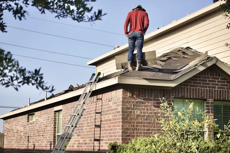 Professional roofer working on a residential roof in East Lancaster